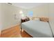 Comfortable bedroom with a light green accent wall, hardwood floors, and a functional workspace at 6067 43Rd N Ter, Kenneth City, FL 33709