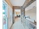Unique foyer with stone walls leading to living area with tile floors at 6067 43Rd N Ter, Kenneth City, FL 33709