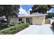 Charming home with manicured front yard, stone accents, and a light-colored tile roof at 6067 43Rd N Ter, Kenneth City, FL 33709