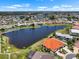 Aerial view showcasing a lakeside community with well-maintained landscaping and serene residential setting at 609 Lively Dr # B, Sun City Center, FL 33573