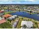 Community aerial view showcasing lakefront property, manicured lawns, and serene residential surroundings at 609 Lively Dr # B, Sun City Center, FL 33573