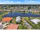 Aerial community view of lakefront homes, lush landscaping, and picturesque residential neighborhood at 609 Lively Dr # B, Sun City Center, FL 33573
