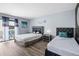 Bright bedroom featuring two beds, wood floors, and sliding glass doors leading to an outdoor seating area at 609 Lively Dr # B, Sun City Center, FL 33573