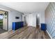 Bedroom featuring accent wall, wood floors and a balcony with a view of the surrounding area at 609 Lively Dr # B, Sun City Center, FL 33573