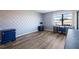 Bedroom with stylish patterned accent wall and bright window overlooking nearby neighborhood at 609 Lively Dr # B, Sun City Center, FL 33573