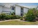 Well-maintained condo exterior with manicured landscaping, lush greenery, and a welcoming entryway at 609 Lively Dr # B, Sun City Center, FL 33573