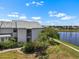 View of condo shows a balcony and patio with nice landscaping and water view at 609 Lively Dr # B, Sun City Center, FL 33573