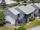 Aerial view showcases the back of the home with screened patios and lush landscaping in a serene community at 609 Lively Dr # B, Sun City Center, FL 33573