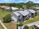 Aerial view of the back of the property, featuring outdoor seating, a screened patio, and well-kept grounds at 609 Lively Dr # B, Sun City Center, FL 33573