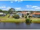 Lovely view of the condo from across the pond, highlighting landscaping at 609 Lively Dr # B, Sun City Center, FL 33573