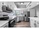 Modern kitchen featuring stainless steel appliances, light gray cabinetry, and a stylish backsplash at 609 Lively Dr # B, Sun City Center, FL 33573