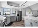 Bright kitchen with stainless steel refrigerator, gray cabinets, and view of breakfast nook at 609 Lively Dr # B, Sun City Center, FL 33573