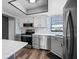 Kitchen featuring stainless steel appliances, gray cabinets, and island with white marble countertops at 609 Lively Dr # B, Sun City Center, FL 33573