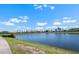 Scenic lake view surrounded by lush landscaping and beautiful homes under a clear blue sky at 609 Lively Dr # B, Sun City Center, FL 33573