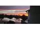 Beautiful water view showing a colorful sunset reflected on a large pond and neighborhood at 609 Lively Dr # B, Sun City Center, FL 33573