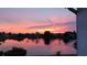 Breathtaking sunset view reflecting vibrant colors across a serene lake surrounded by homes at 609 Lively Dr # B, Sun City Center, FL 33573