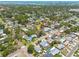 Aerial view of a residential neighborhood with lush trees, showcasing the property's location with nearby water views at 6114 7Th S Ave, Gulfport, FL 33707