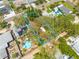 Aerial view of the property highlighting its location, surrounding trees, pool, and sun deck at 6114 7Th S Ave, Gulfport, FL 33707