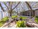 Beautiful backyard with a cozy seating area around a fire pit, surrounded by lush greenery and mature trees at 6114 7Th S Ave, Gulfport, FL 33707