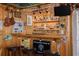 Custom bar area featuring wood finishes, ample shelving, and decorative lighting at 6114 7Th S Ave, Gulfport, FL 33707