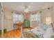 Cozy bedroom with a wicker bed frame, a desk by the window, hardwood floors, and natural light at 6114 7Th S Ave, Gulfport, FL 33707