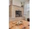 Close-up of the brick fireplace featuring an ornate metal screen and decorative mantel at 6114 7Th S Ave, Gulfport, FL 33707