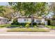 Inviting one-story home boasts beautiful landscaping, a circular brick driveway, and a serene, tree-covered yard at 6114 7Th S Ave, Gulfport, FL 33707