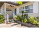 Inviting front porch with lush tropical landscaping, a charming railing, and a welcoming entrance at 6114 7Th S Ave, Gulfport, FL 33707