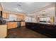Spacious kitchen with dark wood cabinetry, granite countertops, stainless steel appliances, and open layout at 6114 7Th S Ave, Gulfport, FL 33707