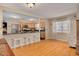 Open kitchen and living area with granite countertops, stainless steel appliances, and hardwood floors at 6114 7Th S Ave, Gulfport, FL 33707