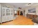 Spacious living room with hardwood floors, a decorative china cabinet, and ample space for entertaining at 6114 7Th S Ave, Gulfport, FL 33707