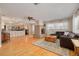 Open-concept living room with hardwood floors, a brick fireplace, and seamless access to the kitchen at 6114 7Th S Ave, Gulfport, FL 33707