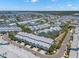 Expansive aerial view of waterfront townhomes with lush landscaping and community surroundings at 616 Garland Cir, Indian Rocks Beach, FL 33785