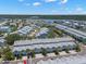 Panoramic aerial view of waterfront townhomes with stunning views of the bay and meticulous landscaping at 616 Garland Cir, Indian Rocks Beach, FL 33785