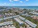 Scenic aerial view of townhomes surrounded by water with the ocean in the background at 616 Garland Cir, Indian Rocks Beach, FL 33785