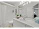 Well-lit bathroom featuring a shower-tub combo, vanity with plants, and ample storage space at 616 Garland Cir, Indian Rocks Beach, FL 33785