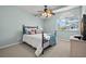 Cozy bedroom featuring a ceiling fan, window, and stylish decor, creating a serene retreat at 616 Garland Cir, Indian Rocks Beach, FL 33785