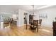 Bright dining room features hardwood floors and a modern chandelier fixture at 616 Garland Cir, Indian Rocks Beach, FL 33785
