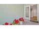 Inviting entrance with red flowers and a glimpse of the bright interior staircase at 616 Garland Cir, Indian Rocks Beach, FL 33785