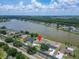 Stunning lakefront home featuring a private pool and lush landscaping on a beautiful day with amazing water views at 6425 Clair Shore Dr, Apollo Beach, FL 33572