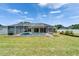 Spacious backyard with screened pool, patio, and verdant lawn for ultimate outdoor enjoyment at 6425 Clair Shore Dr, Apollo Beach, FL 33572