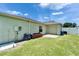 A backyard features a well-maintained lawn, garage, and a clean, minimalist design at 6425 Clair Shore Dr, Apollo Beach, FL 33572