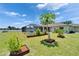 Spacious backyard with landscaped garden beds, pool, and screened lanai at 6425 Clair Shore Dr, Apollo Beach, FL 33572