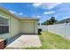 Backyard featuring a well-manicured lawn and an attached garage, perfect for outdoor activities at 6425 Clair Shore Dr, Apollo Beach, FL 33572