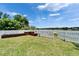 Fenced backyard with planters and lake access at 6425 Clair Shore Dr, Apollo Beach, FL 33572