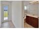 Bathroom with door to the backyard, vanity, and toilet at 6425 Clair Shore Dr, Apollo Beach, FL 33572
