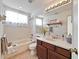 Updated bathroom boasts a vanity with stylish mirror, tub and tile at 6425 Clair Shore Dr, Apollo Beach, FL 33572