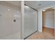 This bathroom features a step-in shower with glass door and a view of the walk-in closet at 6425 Clair Shore Dr, Apollo Beach, FL 33572
