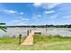 Wooden dock leading to a tranquil lake at 6425 Clair Shore Dr, Apollo Beach, FL 33572
