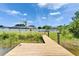 Private backyard dock with lake access and nearby pool at 6425 Clair Shore Dr, Apollo Beach, FL 33572